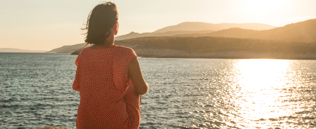 woman staring out over the ocean | [reflective learning]