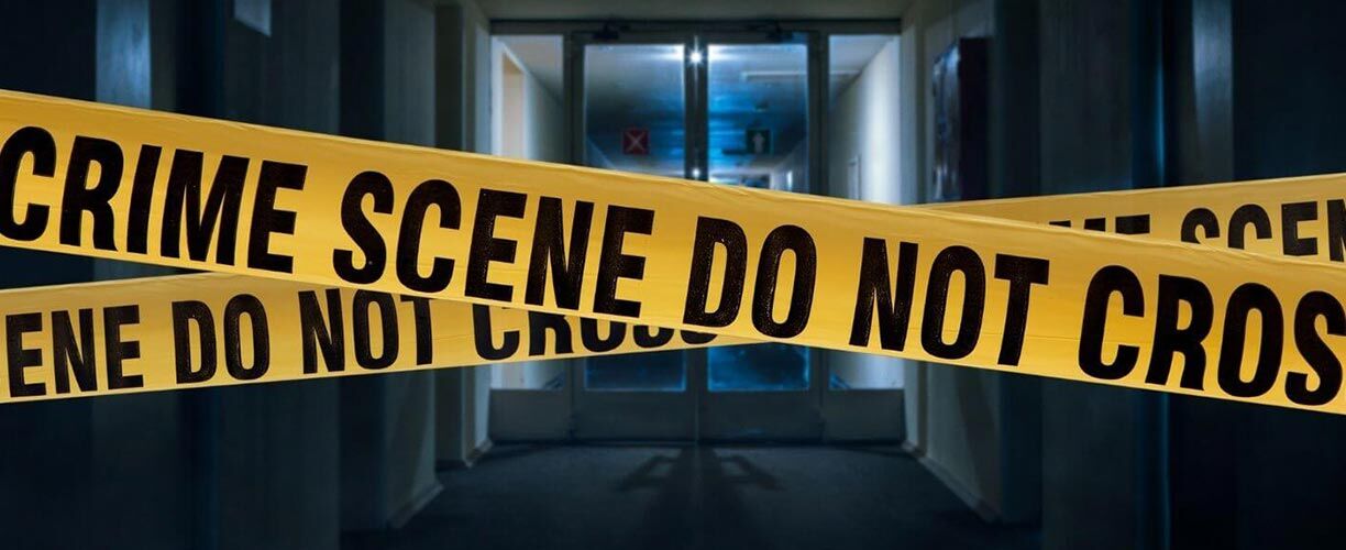 Crime Scene yellow tape is visible and featured across the image. "Crime Scene Do not cross" is printed in black on yellow tape. A glass double door is in the background. Dark shadows and backlight