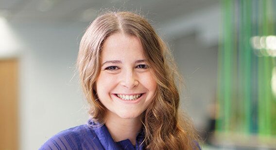 Young woman in purple shirt smiling