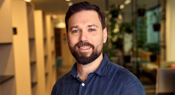 Male counselling student Alex standing at ACAP Sydney campus - close up profile shot