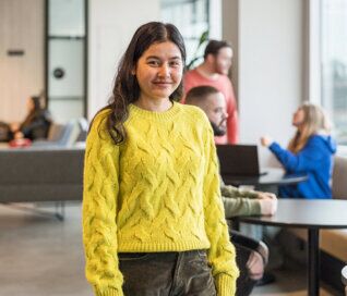 A young female student standing in the common area of ACAP University College Sydney campus (636x544)
