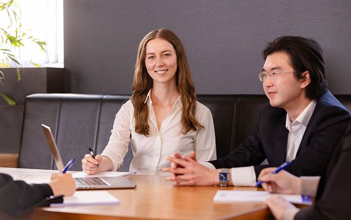 Two Law (PLT) students from ACAP University College in Melbourne sitting at a table in front of notepads and a laptop (724x454)